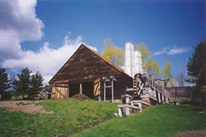 Forge building exterior with waterwheel visible, used for refining iron